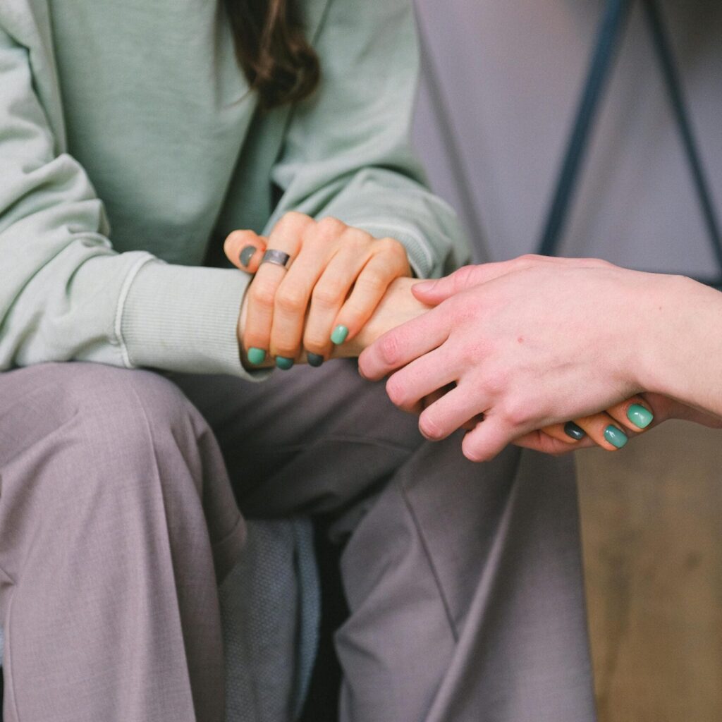 Crop psychologist supporting patient during counseling indoors